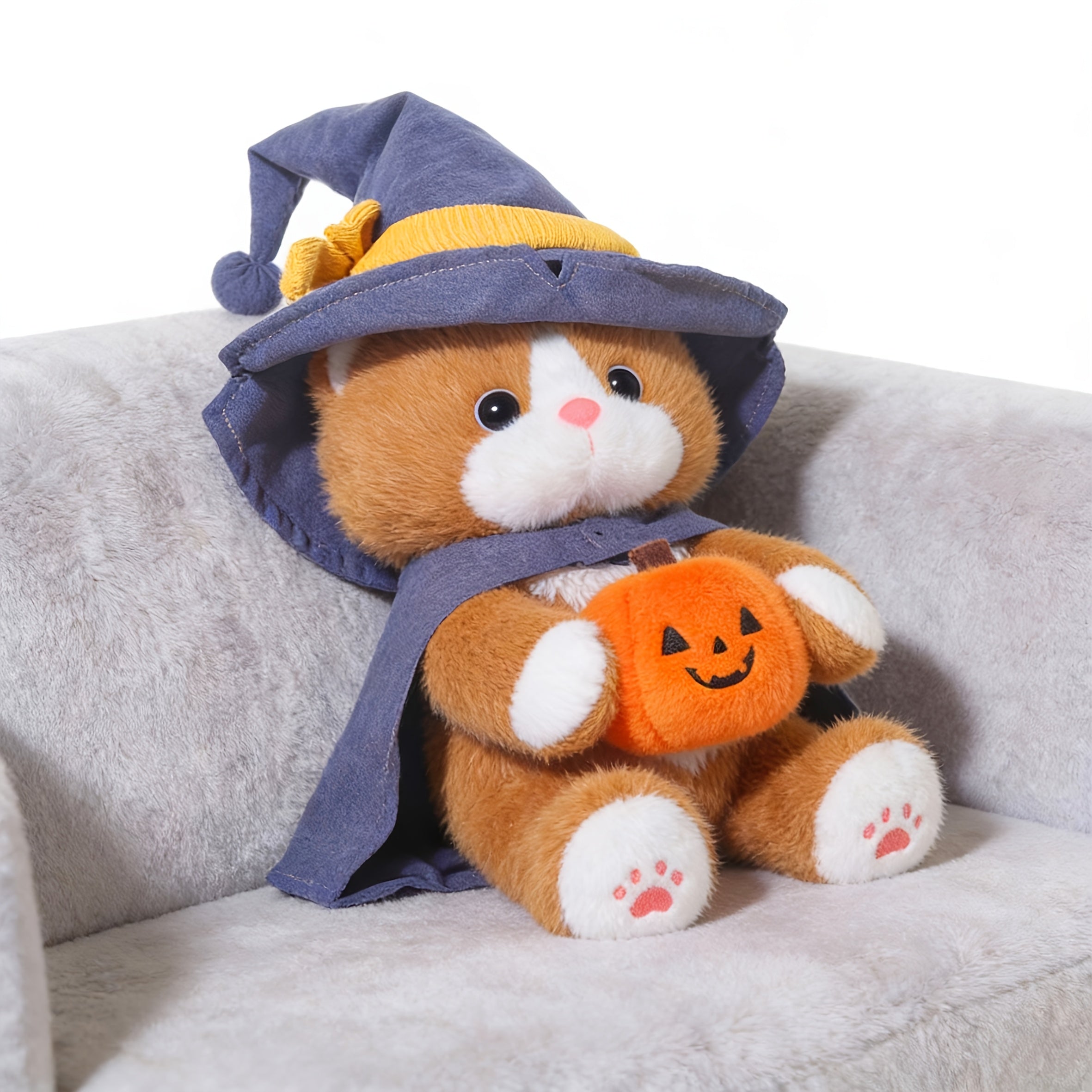 A Soft Toy Cat Adorned with a Wizard'S Hat And Clutching a Pumpkin, Incredibly Charming And Delightful. It Serves As The Perfect Companion for Your Pet, a Buddy for Your Furry, And an Ideal Doll for Engaging with Your Pet
